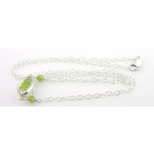 Artisan made sterling silver necklace with peridot gemstones and sterling cage
