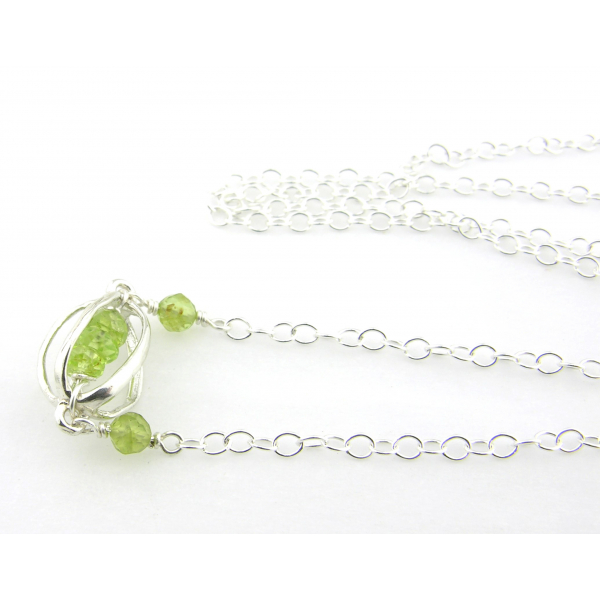 Artisan made sterling silver necklace with peridot gemstones and sterling cage