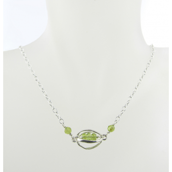 Artisan made sterling silver necklace with peridot gemstones and sterling cage