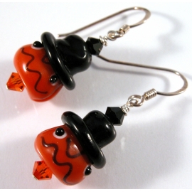 Handmade artisan halloween earrings with orange pumpkin face and sterling silver